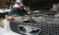Man working on car with hood open