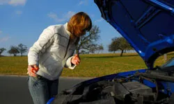 Woman doing maintenance on car