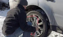 Man putting on tire chains